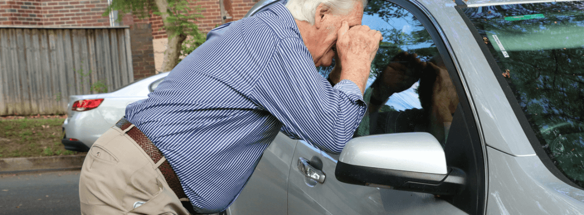 Someone checking out the inside of a car for valuables on view