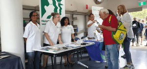 Volunteers on a crime prevention stall at a Hornsby TAFE BBQ