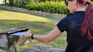 Volunteer doing a letterbox drop during Covid