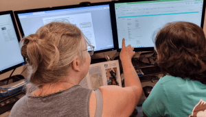 Volunteers at work on a computer screen